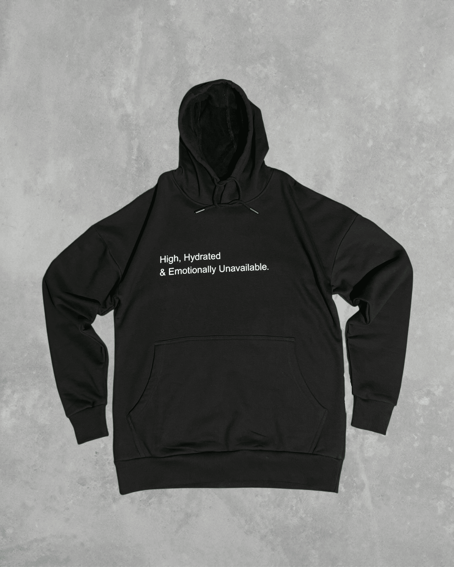 Black heavyweight hoodie with front text 'High, Hydrated & Emotionally Unavailable' – 400 GSM thick premium streetwear hoodie for men and women.