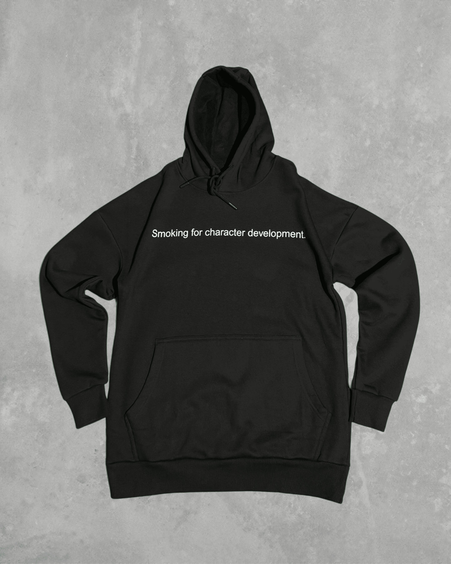 Black heavyweight hoodie with front text 'Smoking for character development' – 400 GSM thick premium streetwear hoodie for men and women.