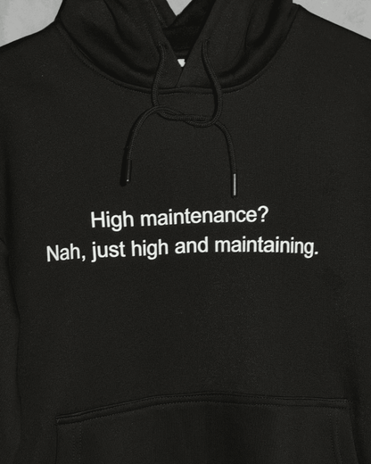 Black heavyweight hoodie with front text 'High maintenance? Nah, just high and maintaining' – 400 GSM thick premium streetwear hoodie for men and women - zoomed in.