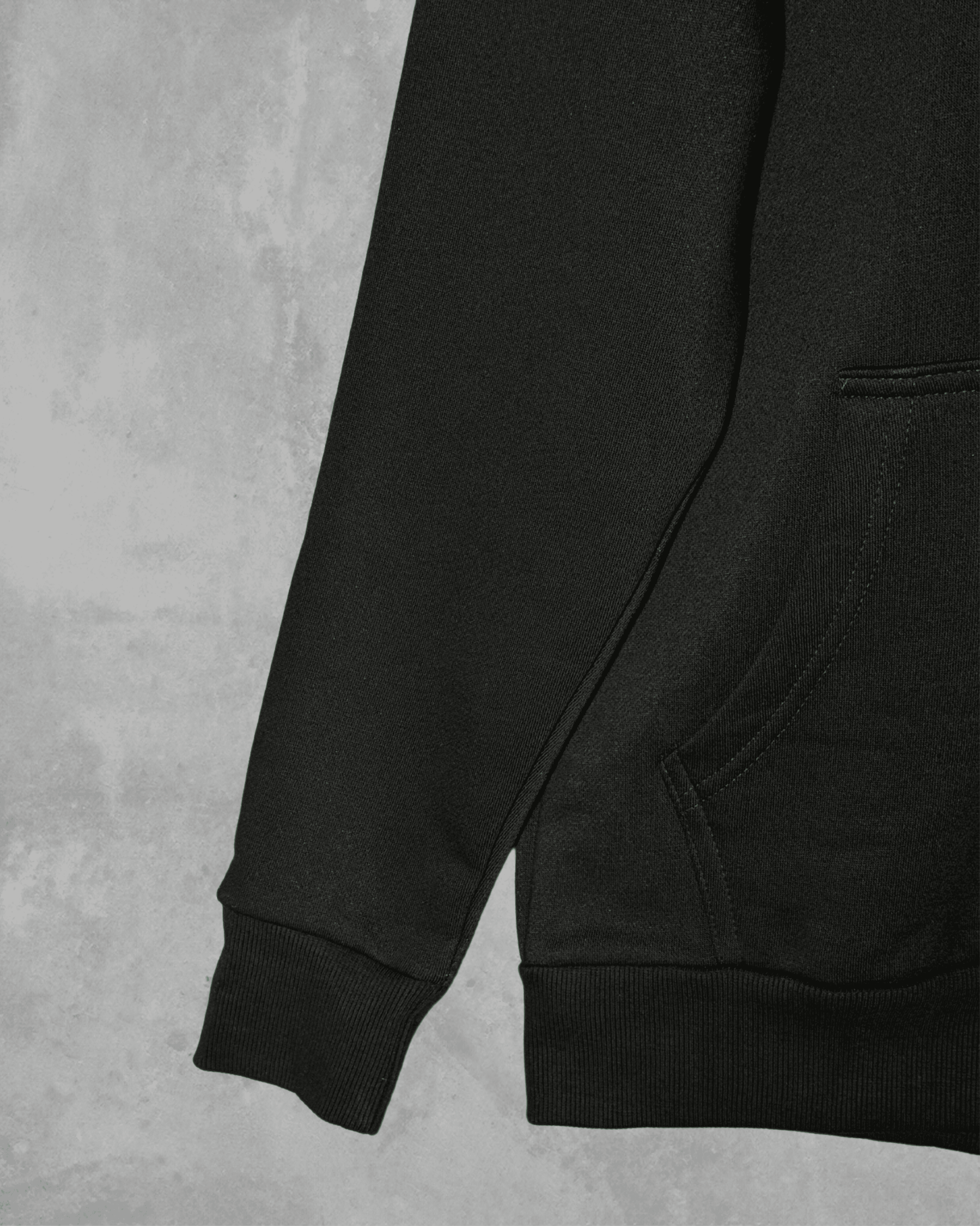 Close-up of a black hoodie on a grey background