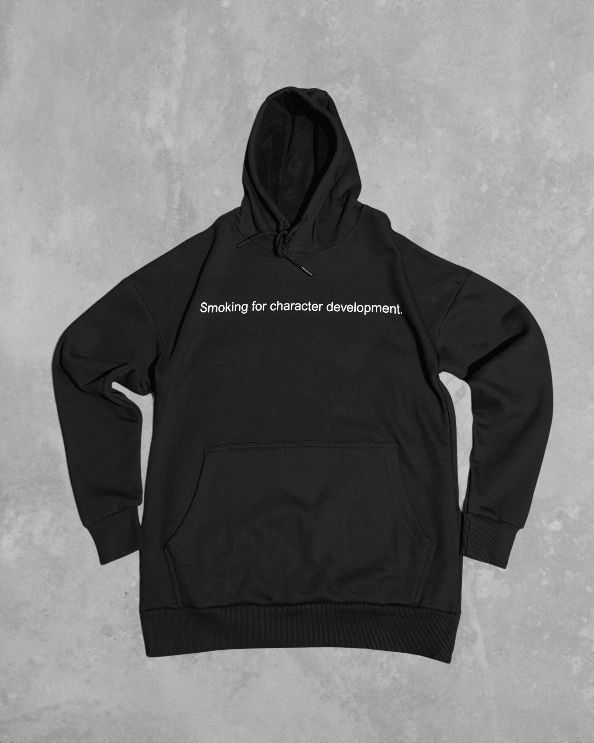 Black heavyweight hoodie with front text 'Smoking for character development' – 400 GSM thick premium streetwear hoodie for men and women.