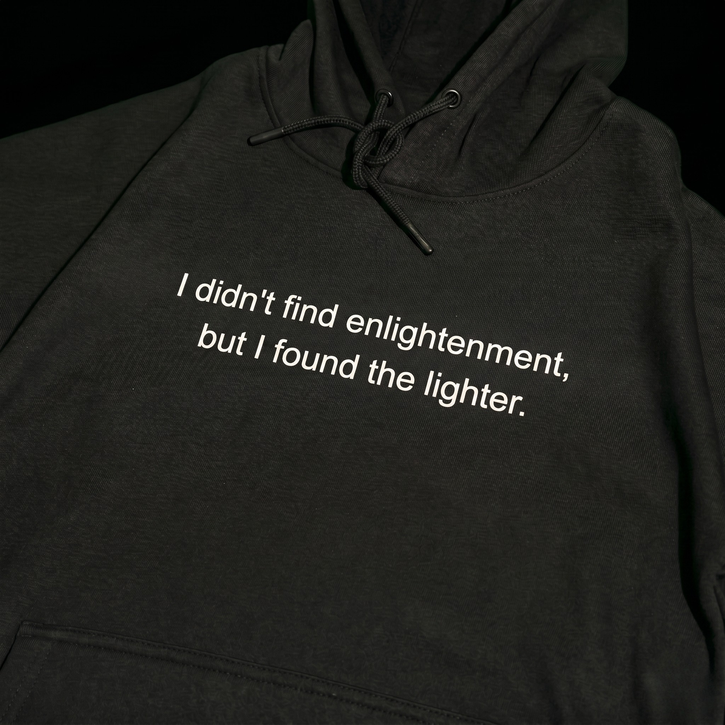 Black hoodie with text 'I didn't find enlightenment, but I found the lighter'