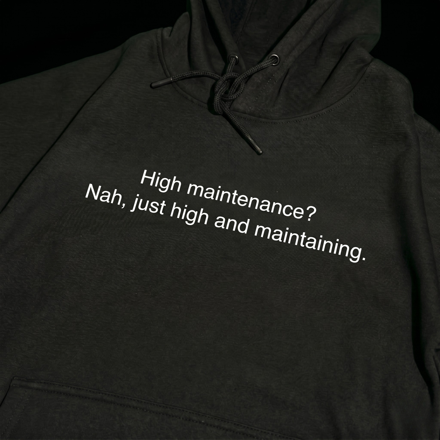 Black thick hoodie with text 'High maintenance? Nah, just high and maintaining'  – 400 GSM premium streetwear hoodie for men and women.