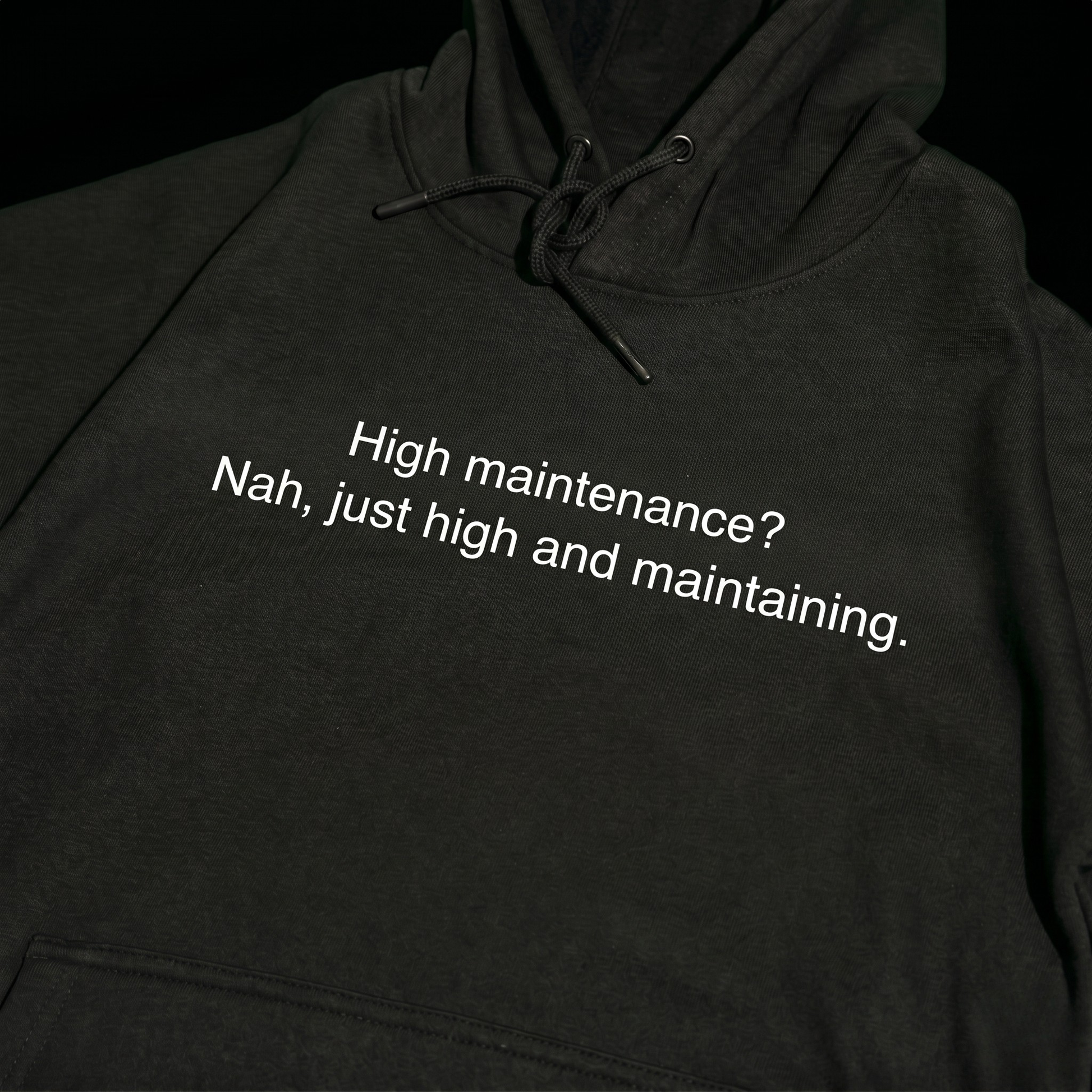 Black thick hoodie with text 'High maintenance? Nah, just high and maintaining'  – 400 GSM premium streetwear hoodie for men and women.